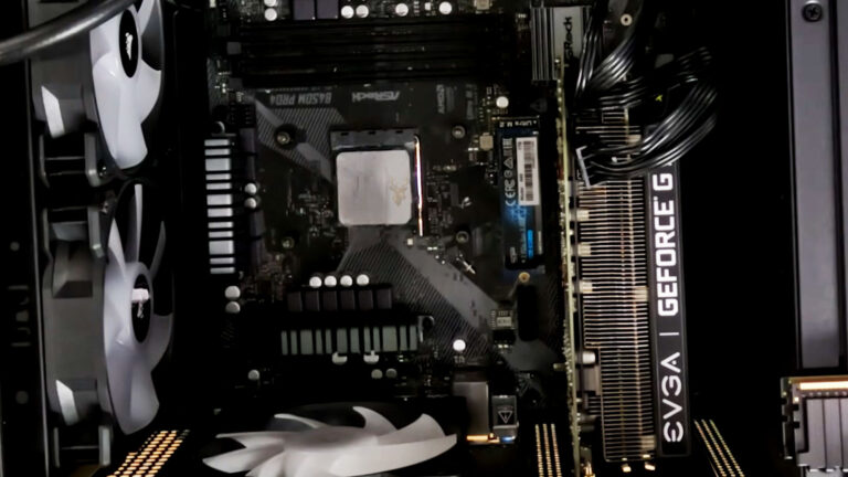 Open desktop computer with fresh thermal paste applied to the CPU during troubleshooting of heat-related intermittent hardware failures.