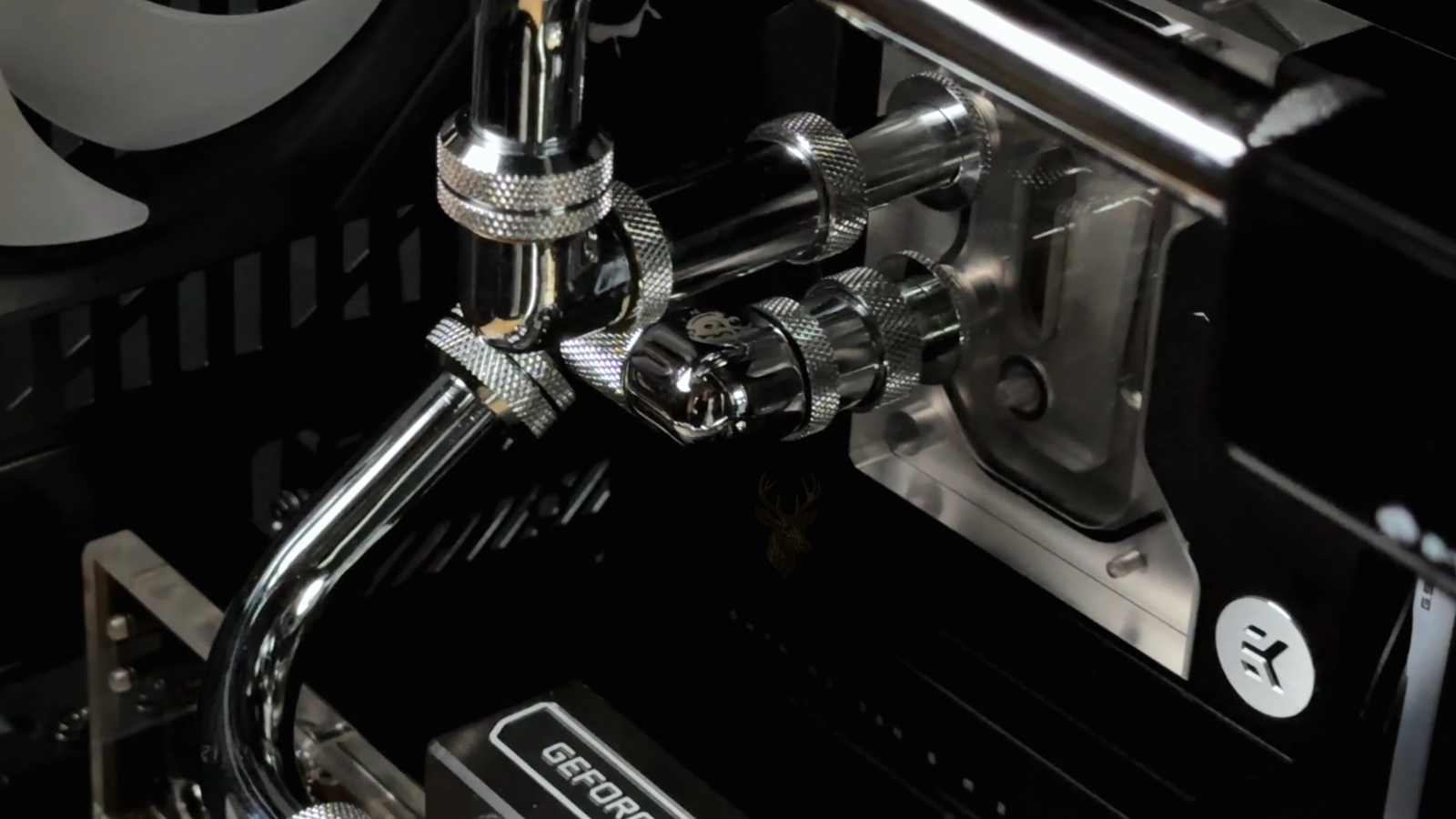 Custom gaming PC with visible GeForce graphics card, hard tube cooling system, and high performance internal hardware