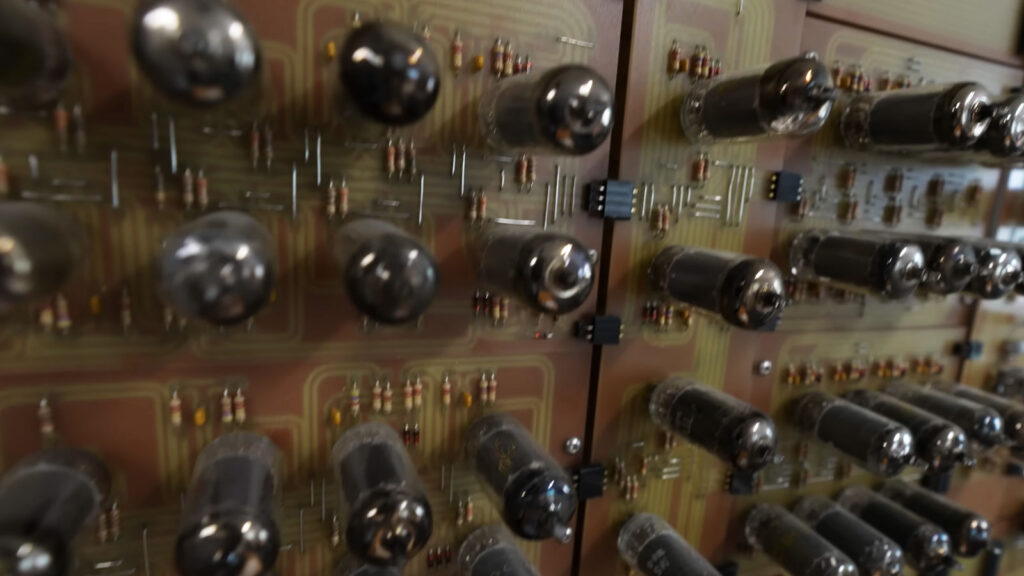Early computer system built with glowing vacuum tubes.