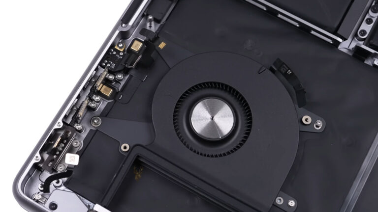 Opened Mac computer with internal components removed near cooling fan
