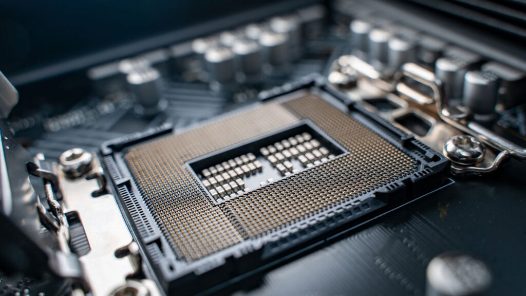 Open CPU socket on a computer motherboard prepared for processor installation.