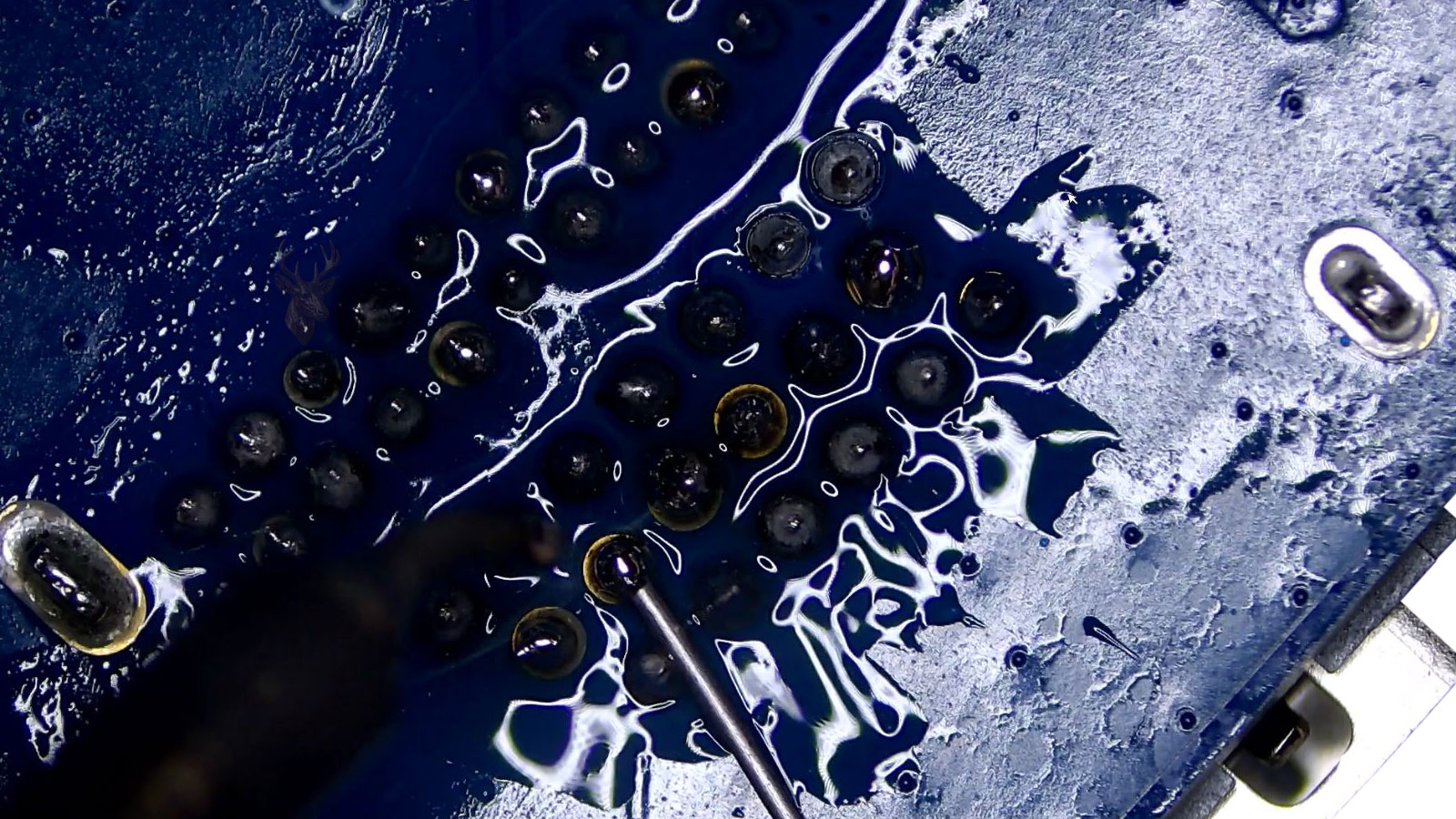 Technician performing board-level soldering repair on a desktop PC motherboard in Miami