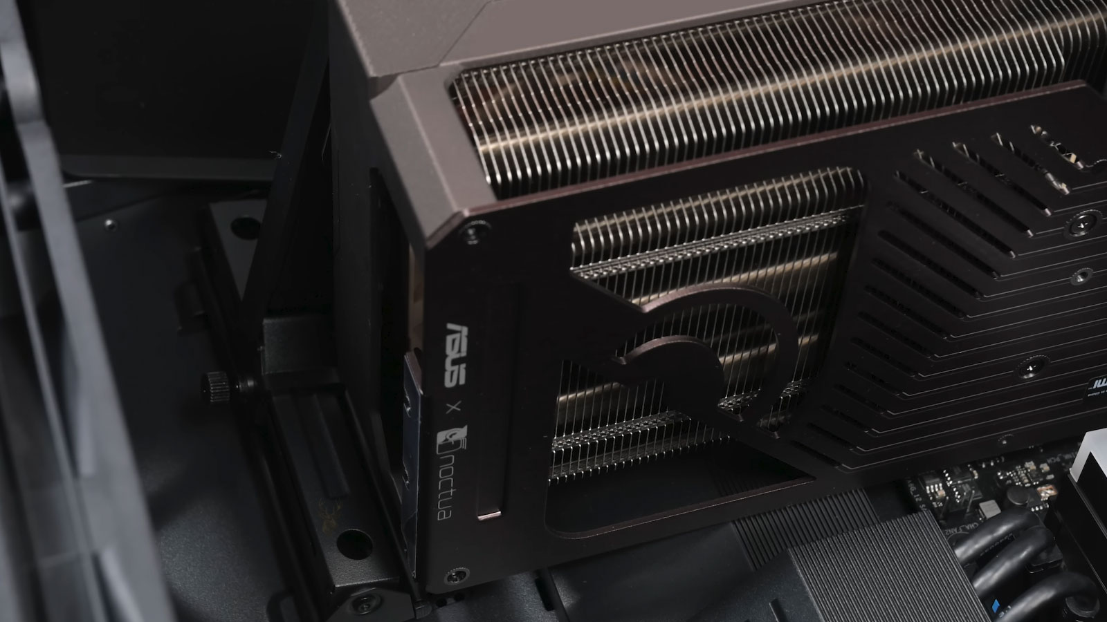ASUS Noctua graphics card being installed inside a desktop computer.