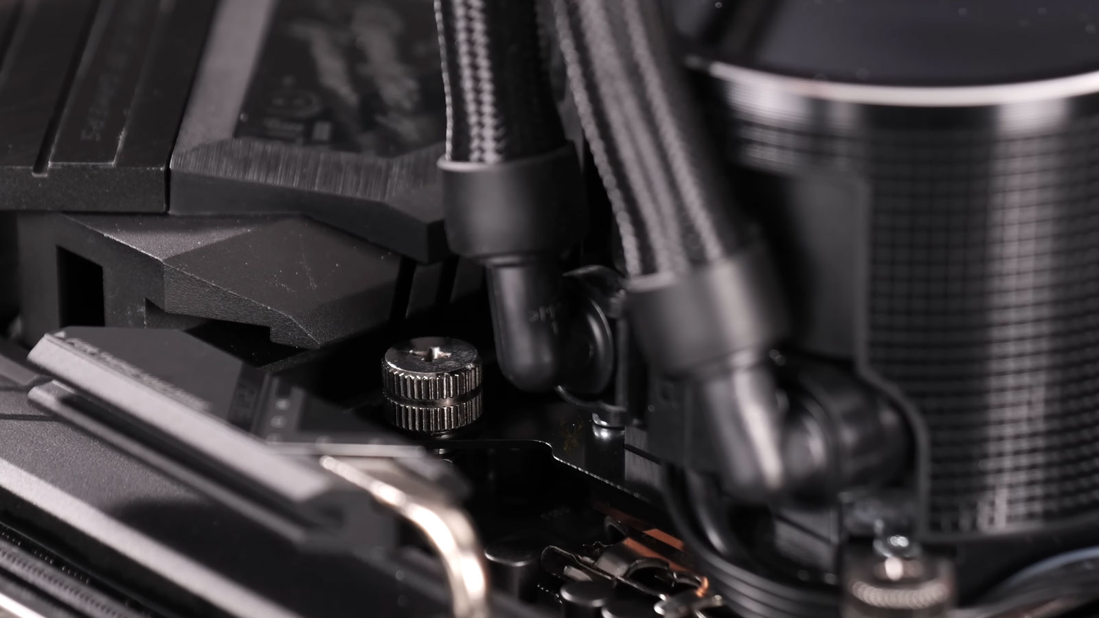 Liquid cooling water pump being installed on top of a computer CPU.