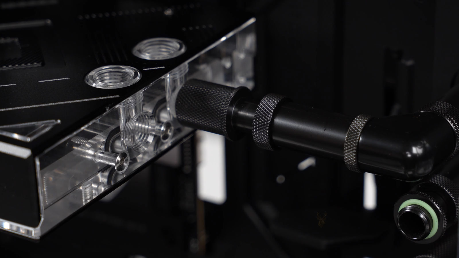 Graphics card connected to a custom liquid cooling system with a metal hard tube.