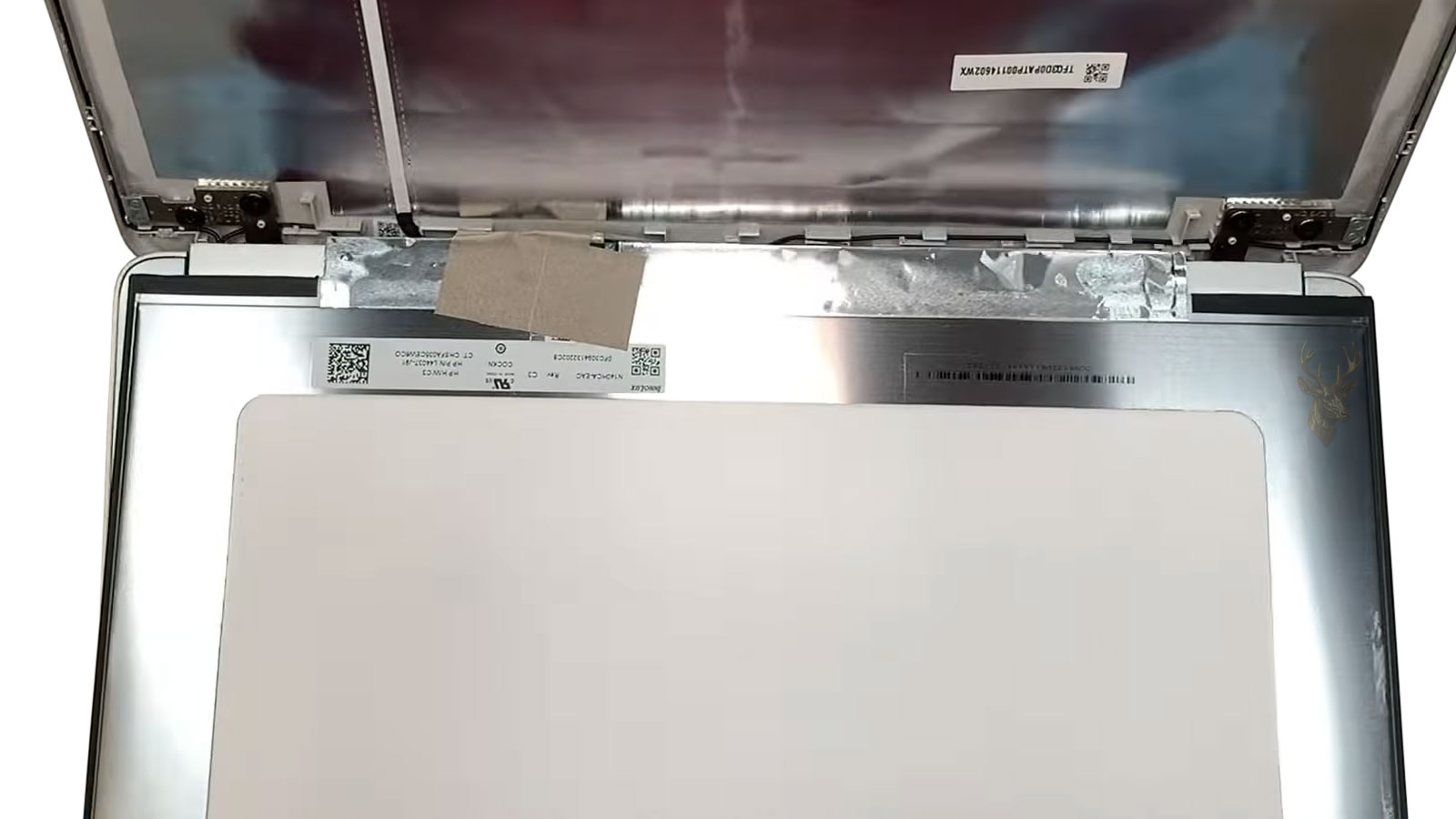 HP laptop with the bezel opened and LCD screen pulled forward during screen replacement