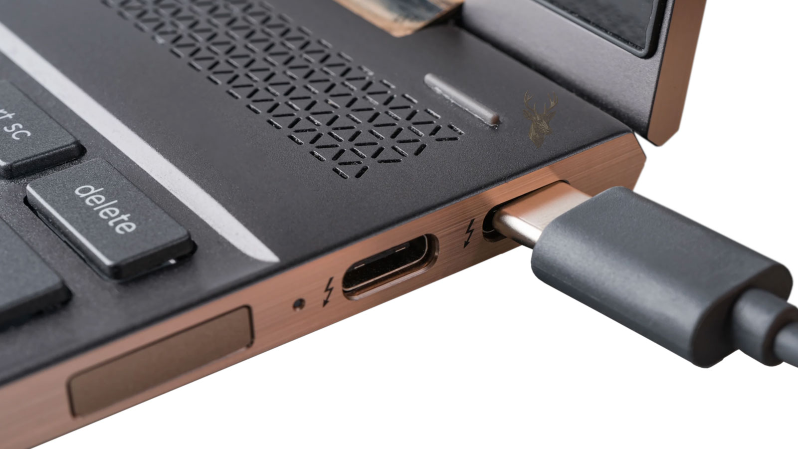USB-C cable being connected to the side charging port of a laptop