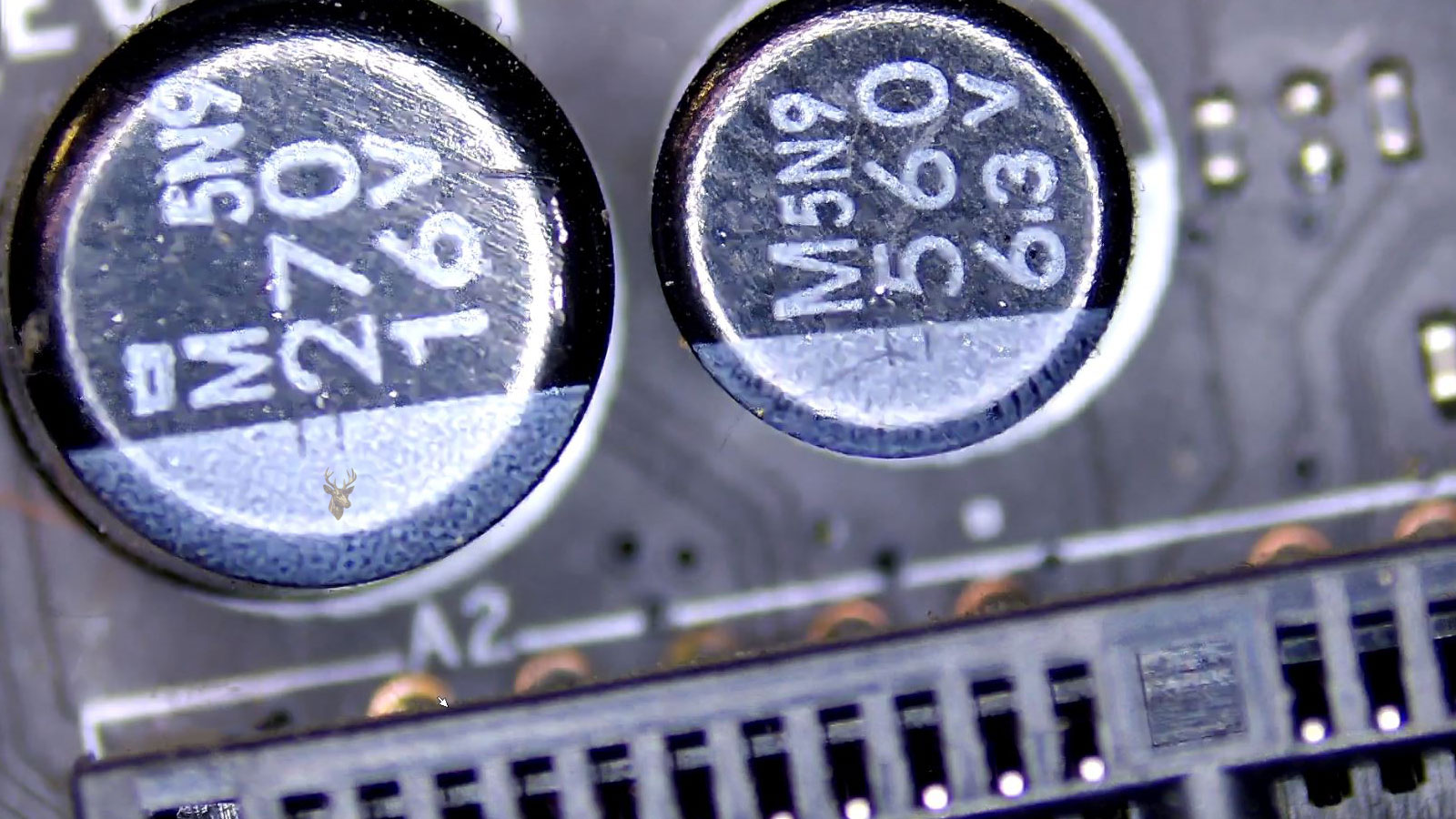 Close-up of a computer circuit board with 270 16V and 560 6.3V capacitors near a 2Amp component.