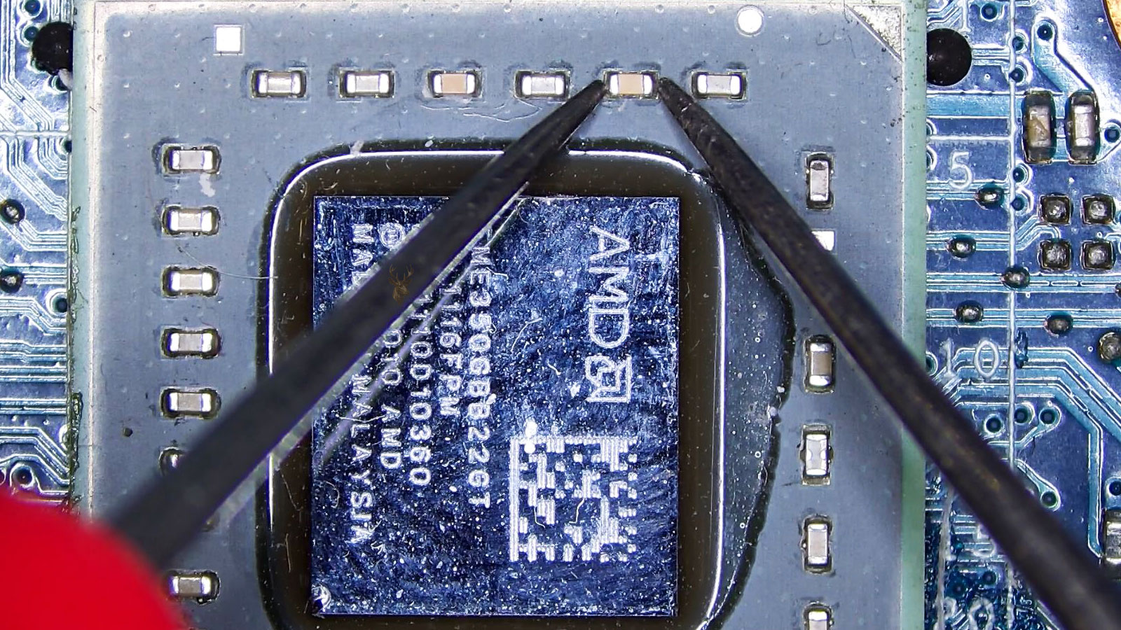 Close-up of an AMD video chip and surrounding electronic components on a computer circuit board.