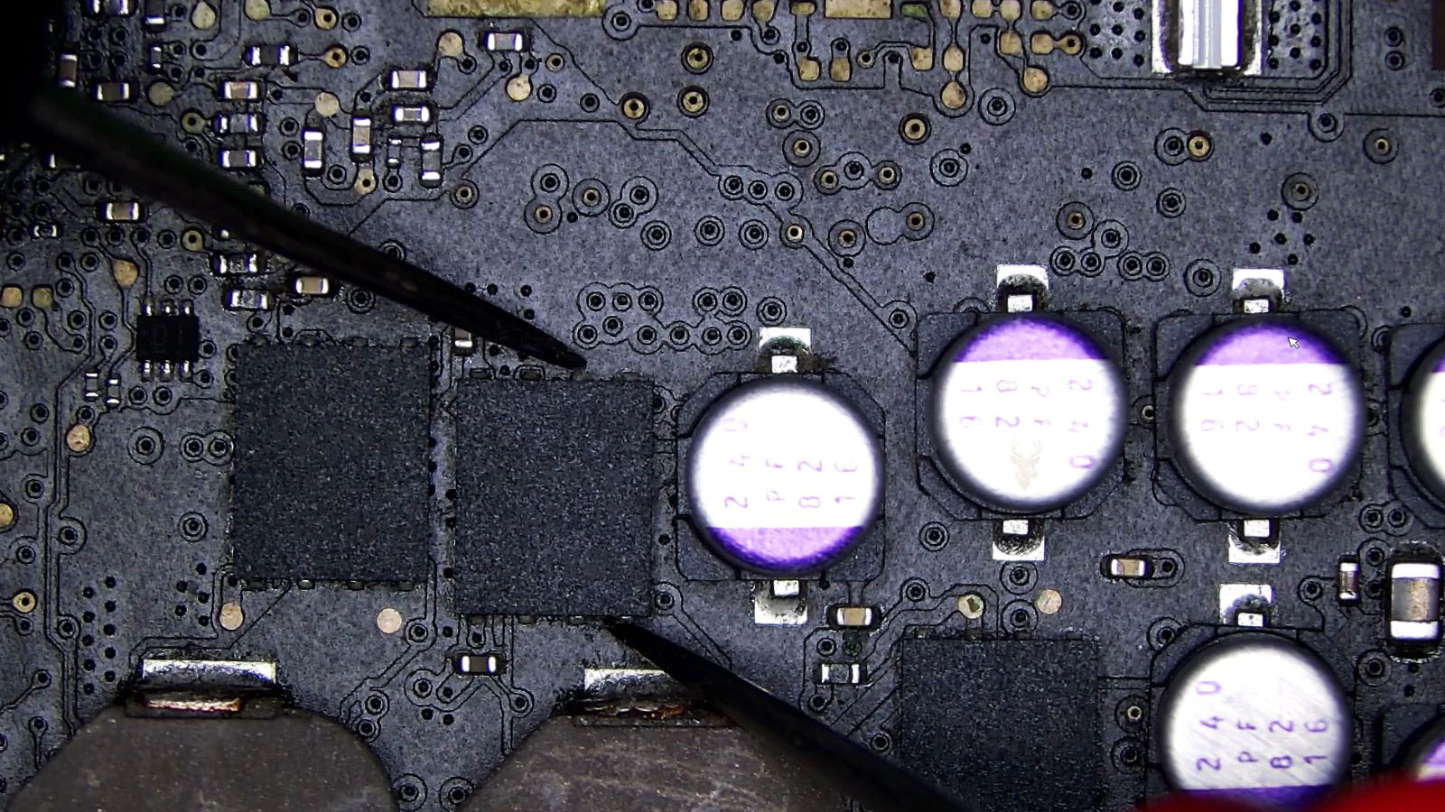 Computer circuit board with multiple controller chips, including one being tested for a possible fault.