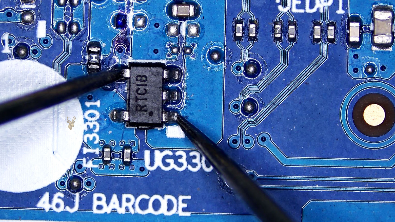 Technician measuring the pins of a five-leg IC chip on a computer circuit board with multimeter probes among capacitors, resistors, and transistors.