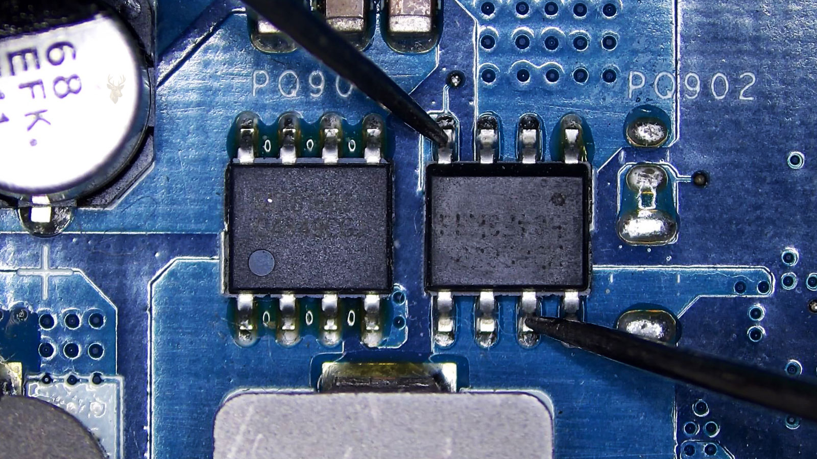 Multimeter probes testing the gate-to-drain connection of a MOSFET on a computer circuit board.