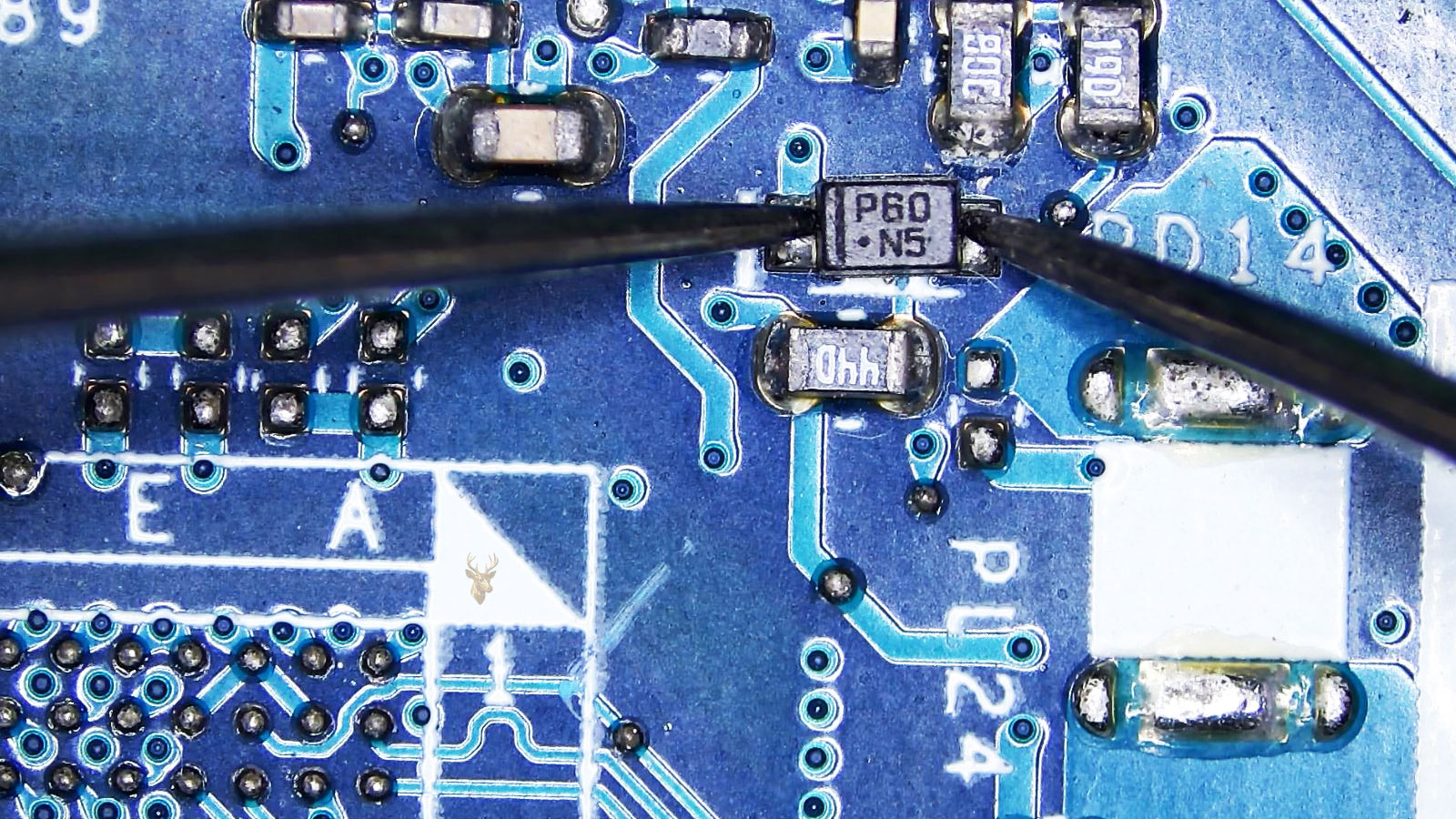 Multimeter probes testing a P60N5 diode on a computer circuit board with surrounding capacitors, resistors, and electronic components.