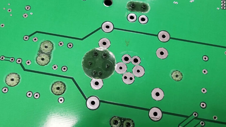 Solder mask being applied to a printed circuit board during an electronic repair.