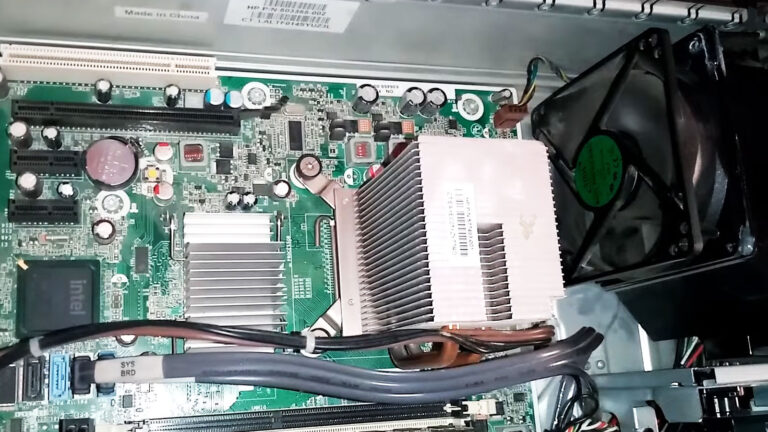 Open desktop computer with the cooling fan spinning momentarily before stopping during the startup process.