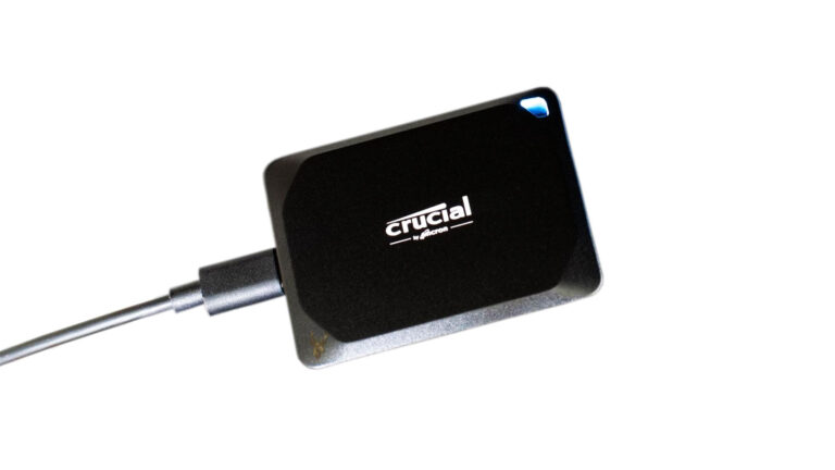 Crucial X10 Pro external SSD connected with the blue status LED illuminated.