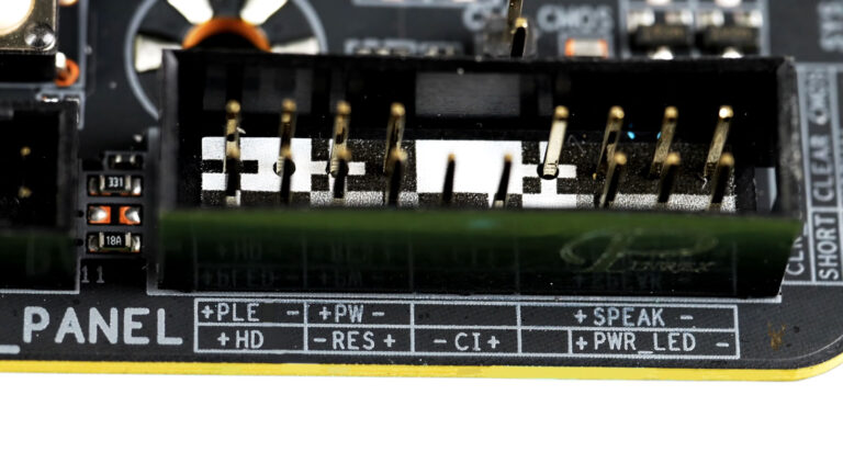 Desktop motherboard front panel header showing power switch, reset switch, hard drive LED, power LED, speaker, and chassis intrusion pins.