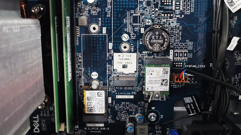 Open Dell desktop tower being inspected for loose internal cables and power connections after shutting off when moved or touched.