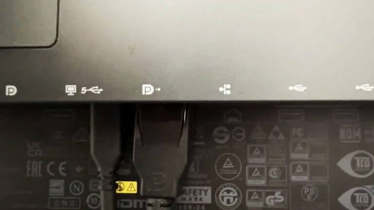 Rear monitor connections showing USB-C and DisplayPort cables configured for a daisy chain multi-monitor setup.