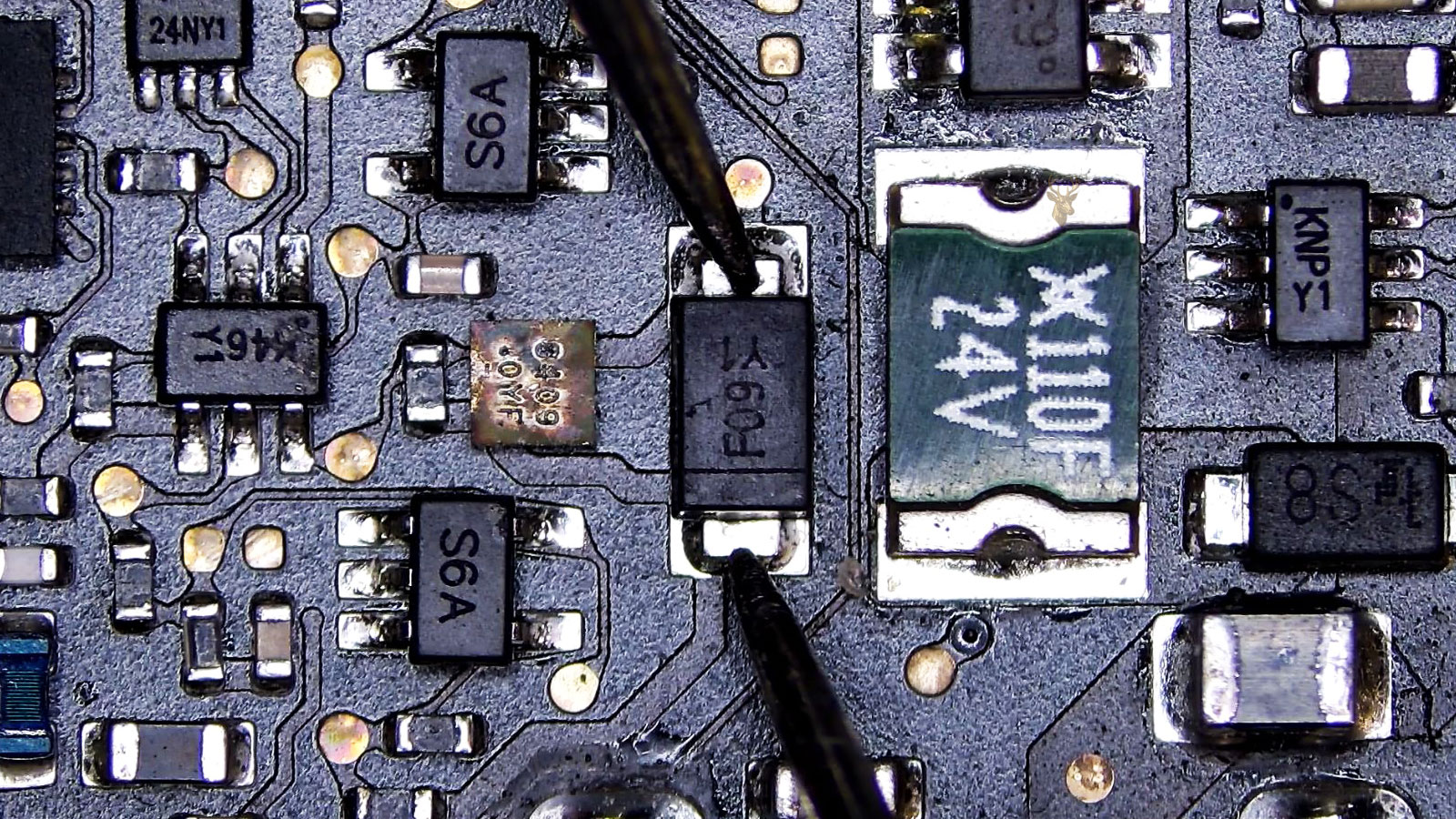 F09 diode being measured in a packed circuit section with mini IC, power IC, transistors, fuses, resistors, and other diodes.