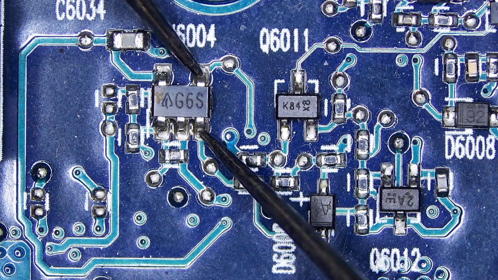 G6S transistor being measured in a computer circuit section with many surrounding transistors and diodes.