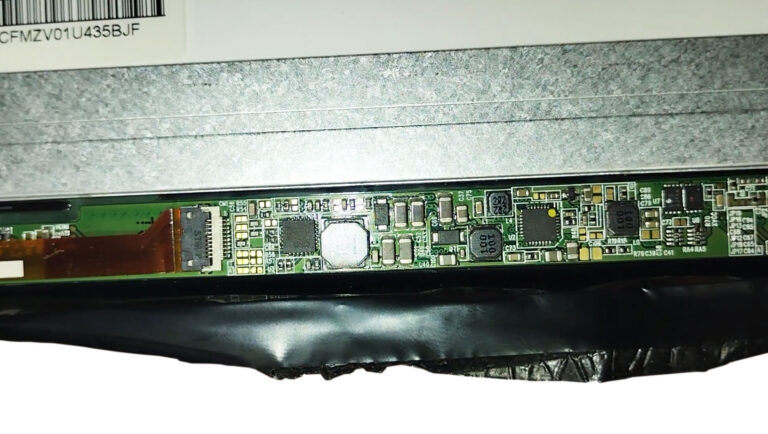 Laptop LCD display with the backlight inverter board exposed during diagnosis of a screen that is only visible under a bright light.