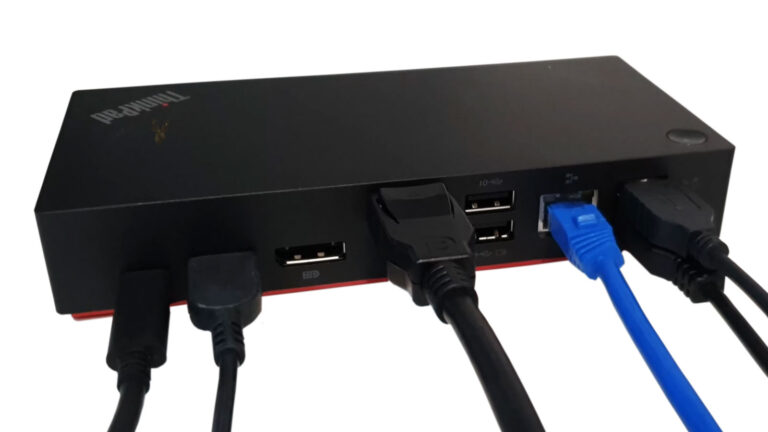 ThinkPad USB-C docking station with multiple cables connected for external displays, networking, and peripheral devices.
