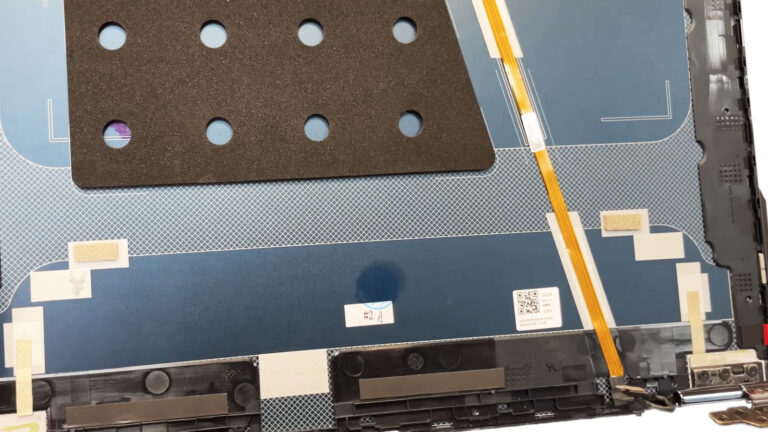 Laptop LCD back cover showing misalignment and physical damage caused by excessive pressure on the display lid.