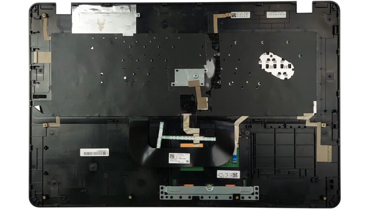 Complete laptop palm rest assembly removed and turned upside down, showing the keyboard, trackpad, and internal flex cables.
