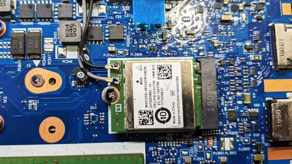 Laptop motherboard with a Wi-Fi card connected to two antenna cables for wireless network communication.