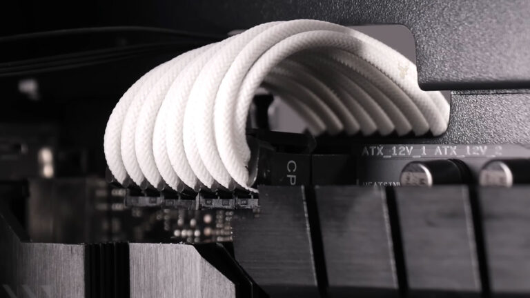Desktop motherboard showing the 12-volt CPU power connector properly connected during inspection of internal power connections.