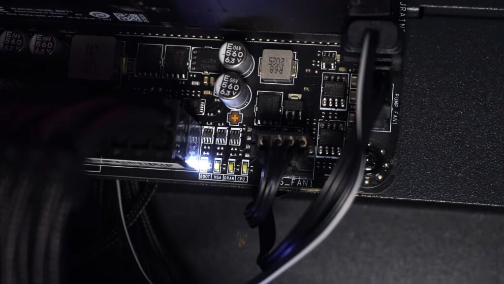 Motherboard debug LED section showing CPU, DRAM, VGA, and BOOT indicators, with the BOOT LED illuminated during startup troubleshooting.