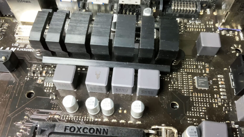 Gigabyte motherboard highlighting the VRM (Voltage Regulator Module) section next to the CPU socket during power delivery troubleshooting.