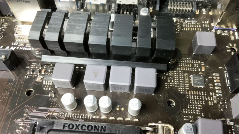 Gigabyte motherboard highlighting the VRM (Voltage Regulator Module) section next to the CPU socket during power delivery troubleshooting.