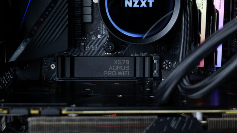 NVMe SSD installed beneath a motherboard heatsink designed to control drive temperature and prevent thermal throttling.