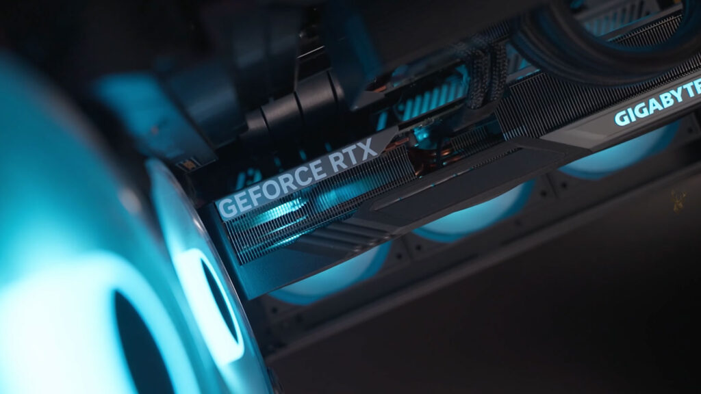 Gigabyte GeForce RTX graphics card mounted vertically with a PCIe riser cable inside a gaming computer.