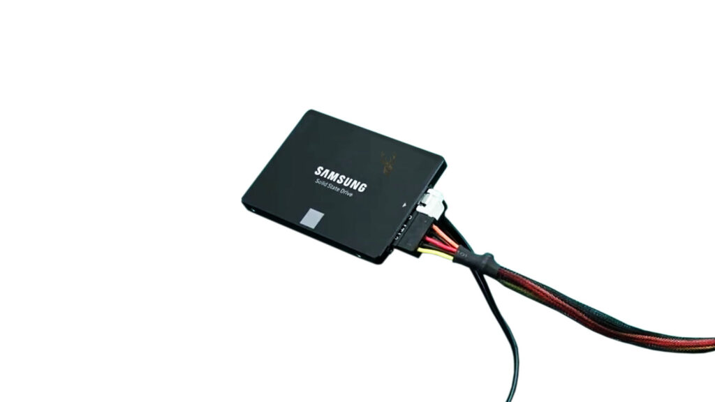 Samsung 2.5-inch solid-state drive connected with SATA data and power cables during troubleshooting of an intermittently disappearing storage device.