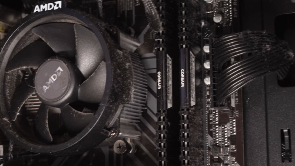 Dusty AMD CPU cooling fan showing common signs of wear that can develop near the end of its service life.