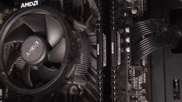 Dusty AMD CPU cooling fan showing common signs of wear that can develop near the end of its service life.