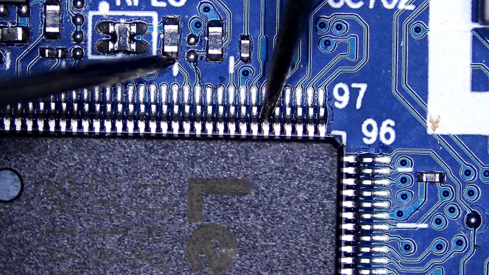 Super IO chip corner being measured from pin 103 to a nearby resistor on the circuit board.