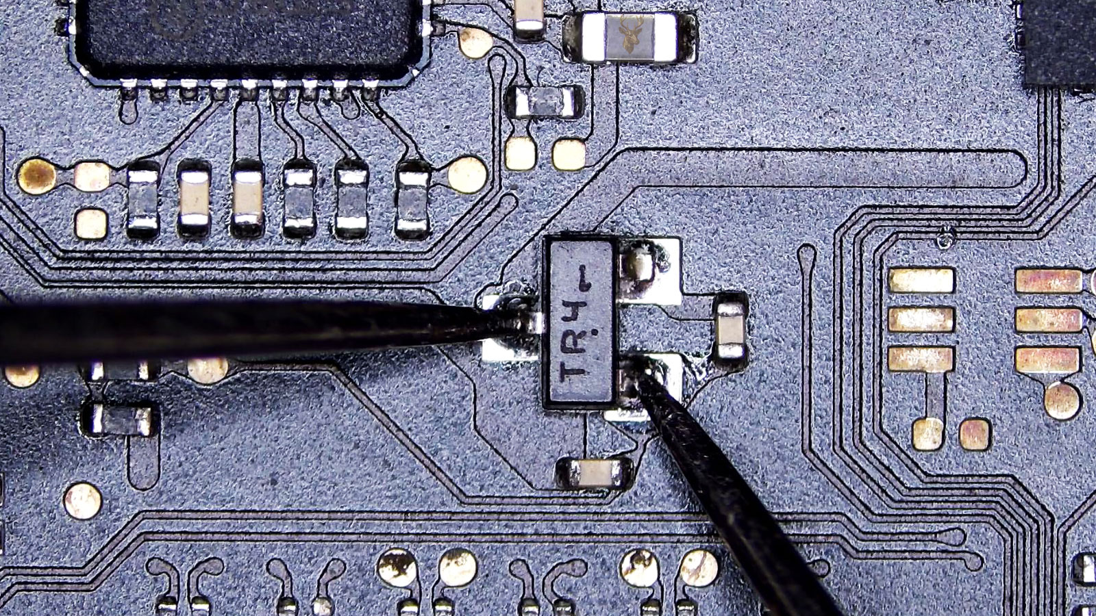 TR4 three-pin transistor being measured from the single pin to one of the two opposite pins.