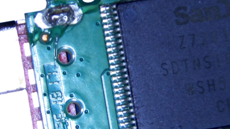 USB flash drive with a failed controller prepared for soldering and data recovery.