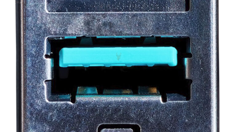 Blue USB connector on a computer circuit board used for high-speed data transfer and power negotiation with compatible devices.