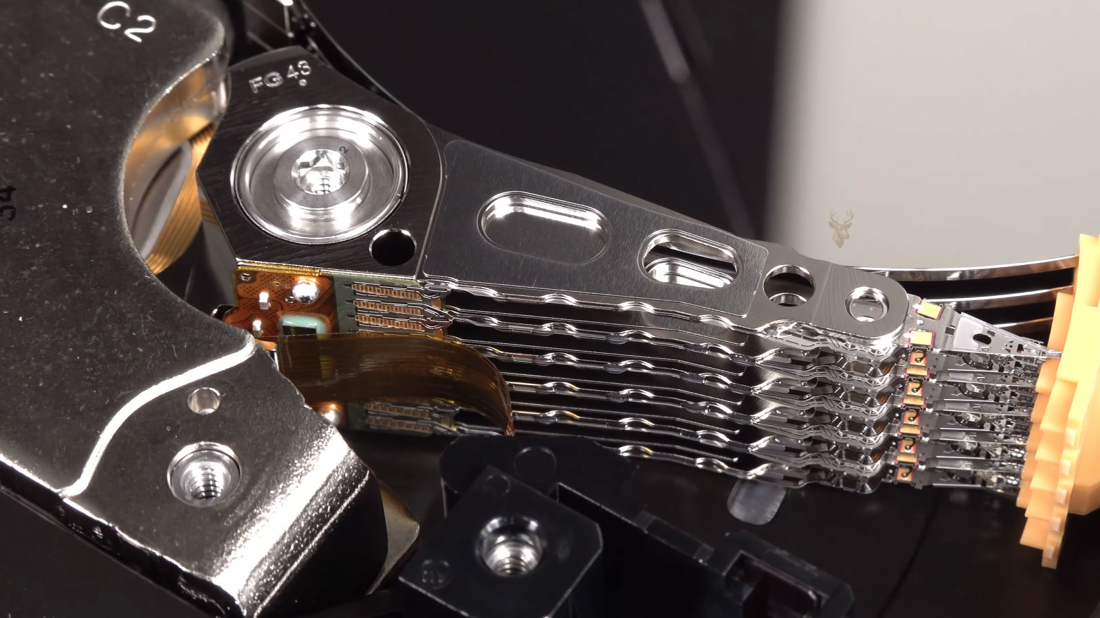 Mechanical hard drive with exposed platters and read/write heads during failure analysis and data recovery.