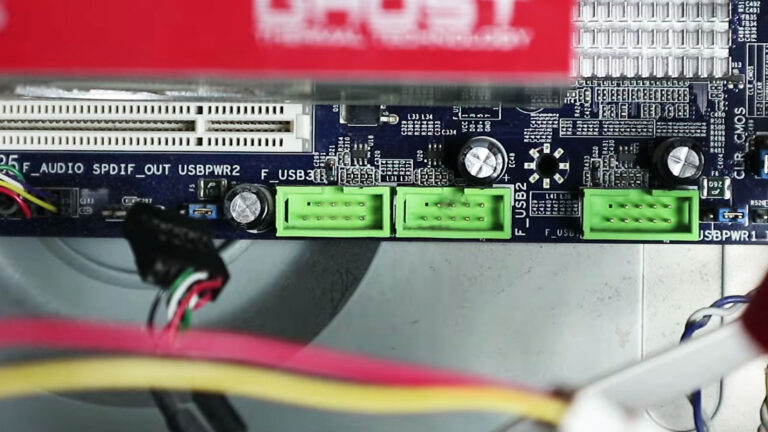Open desktop computer showing an internal USB cable disconnected from the motherboard header.