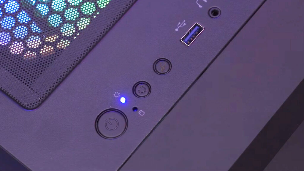 Desktop computer case with the power button illuminated, indicating the system has powered on unexpectedly after being shut down.