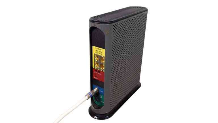 Internet modem with coaxial service connection and four Ethernet LAN ports used to troubleshoot a wired connection limited to 100 Mbps.