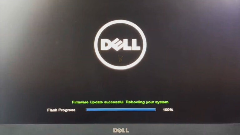 Dell computer displaying a firmware update screen showing the firmware flash completed successfully and the system preparing to reboot.
