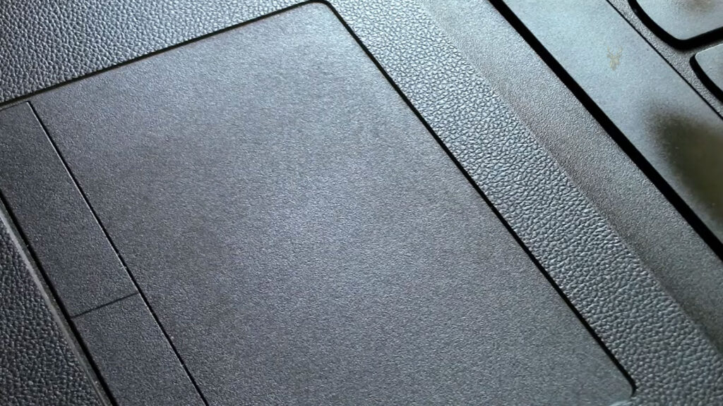 Laptop touchpad being used while the cursor does not respond to finger movement.