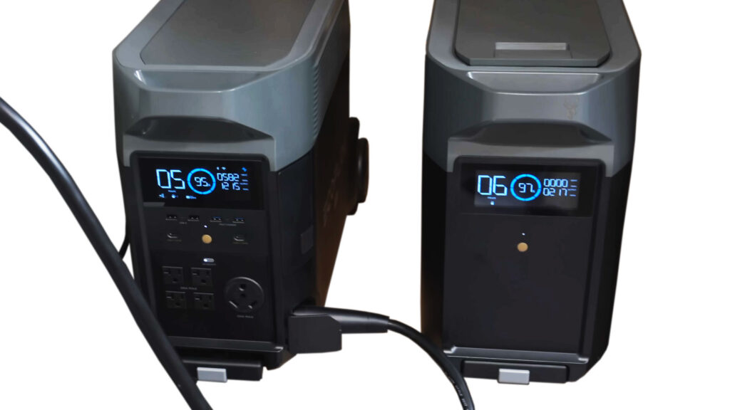 Two uninterruptible power supply (UPS) units powered on and protecting office computer equipment.